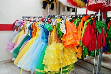 A rack of colorful kids costumes from a custom costume manufacturing factory.